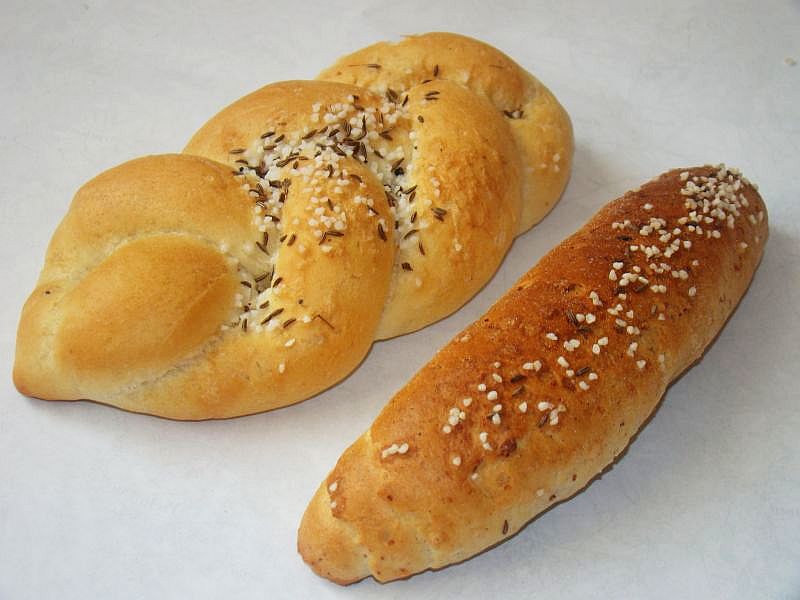 Two loaves of bread with caraway seeds on top