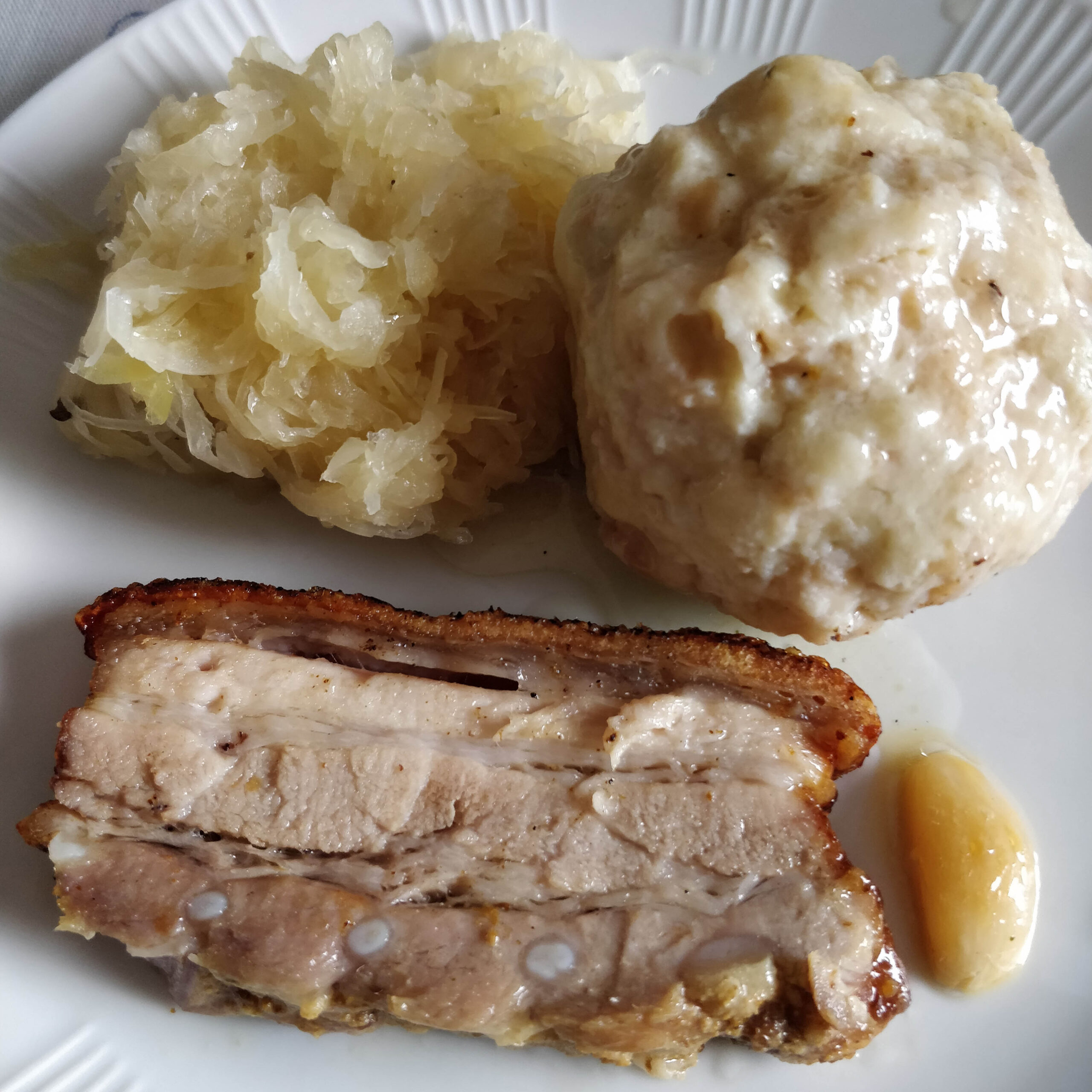 Plate of pork, sauerkraut, and dumpling