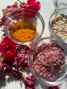 Picture of dried herbs in bowls with some flowers