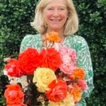 Picture of article author, Janice Cox, holding a bunch of rose flowers