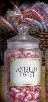 Glass jar of red and white aniseed candies