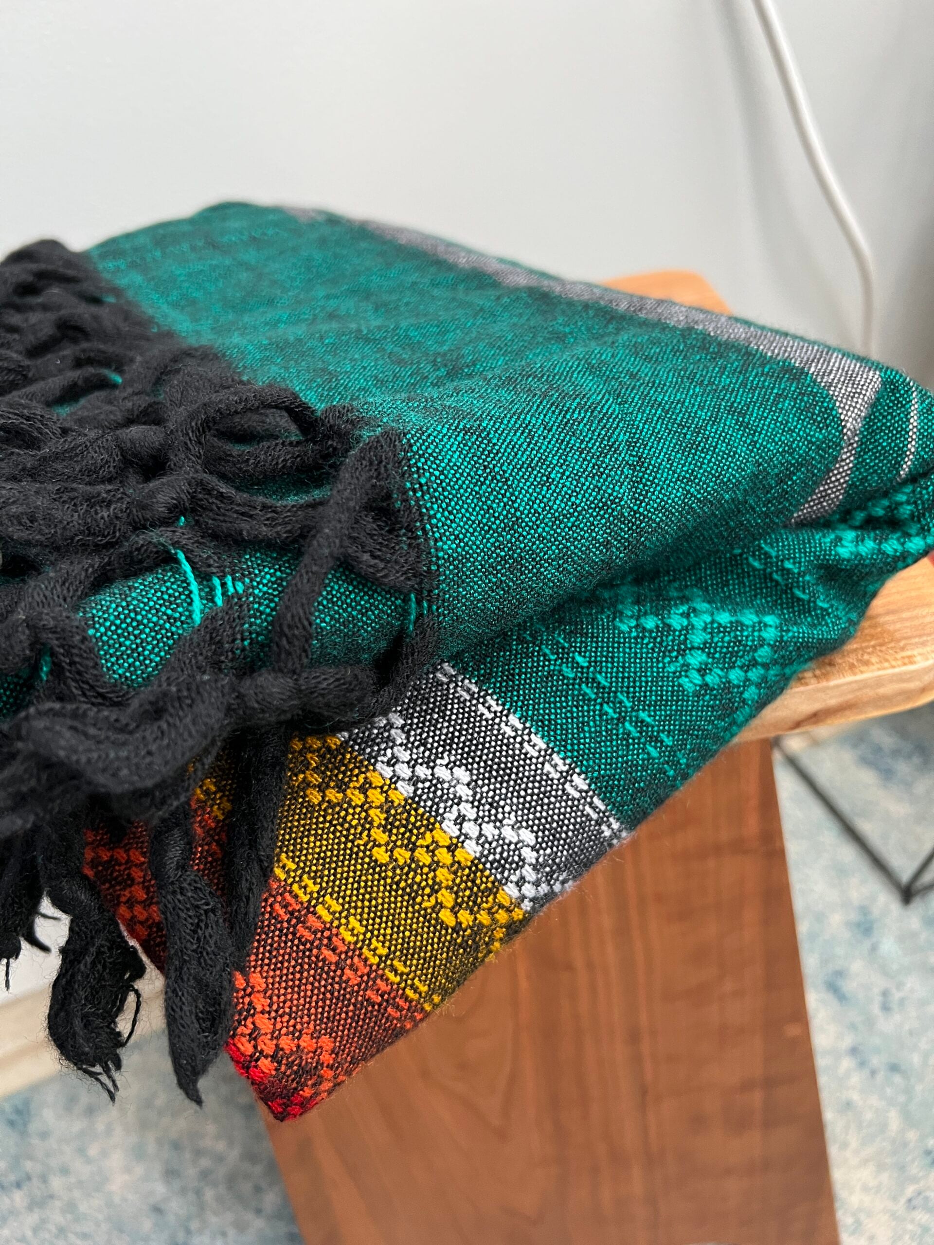 Multicolored, predominately green blanket made from Agave fibers