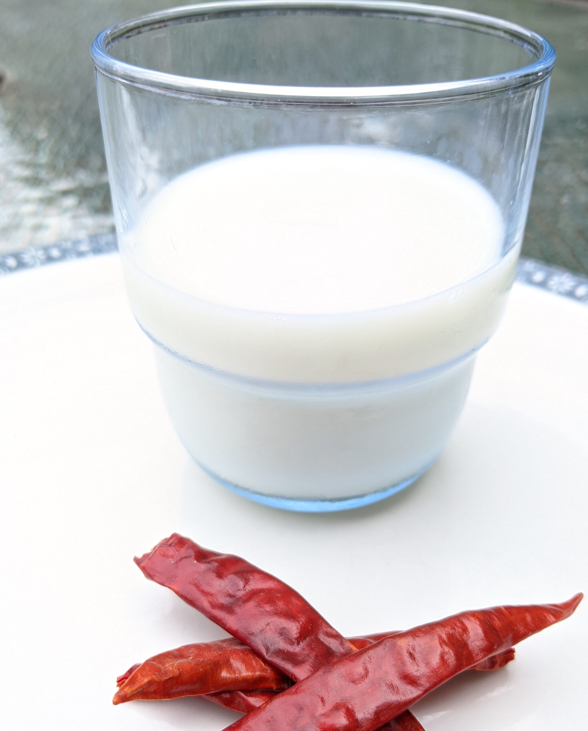 chile peppers and glass of milk
