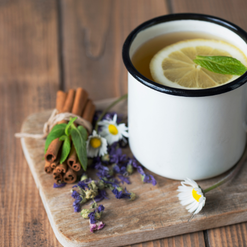 Cup of tea with cinnamon sticks and flowers