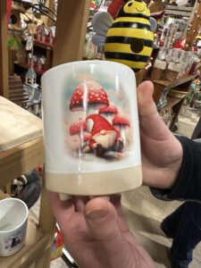 Picture of coffee mug with picture of Amanita mushrooms and garden gnome