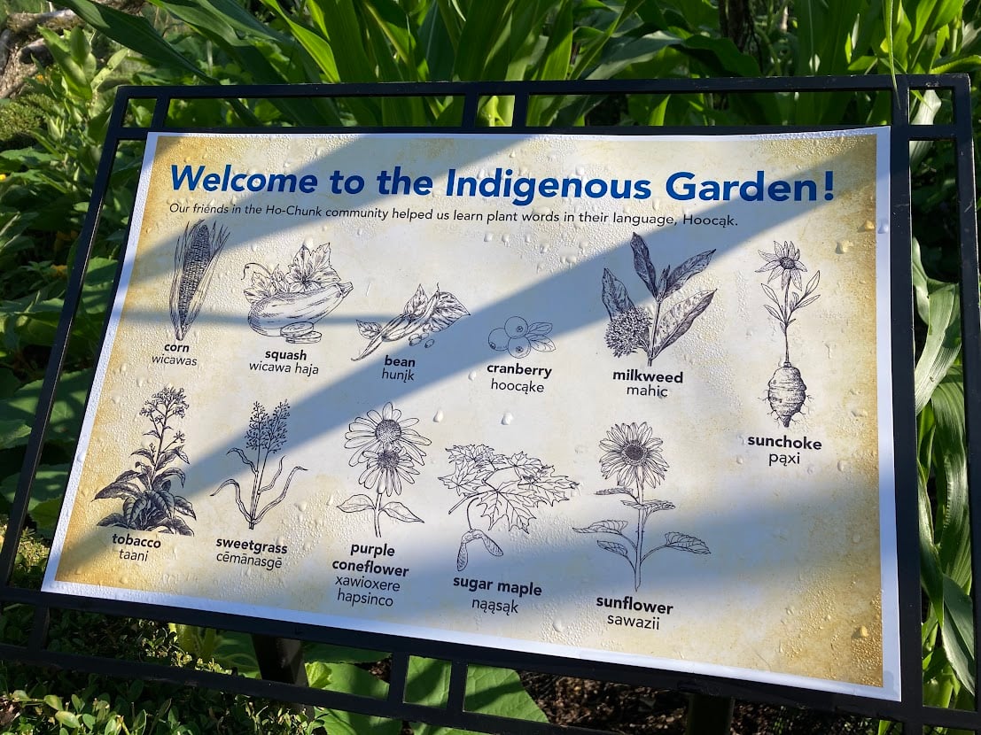 A garden sign with the English and Hoocak words for various plants.