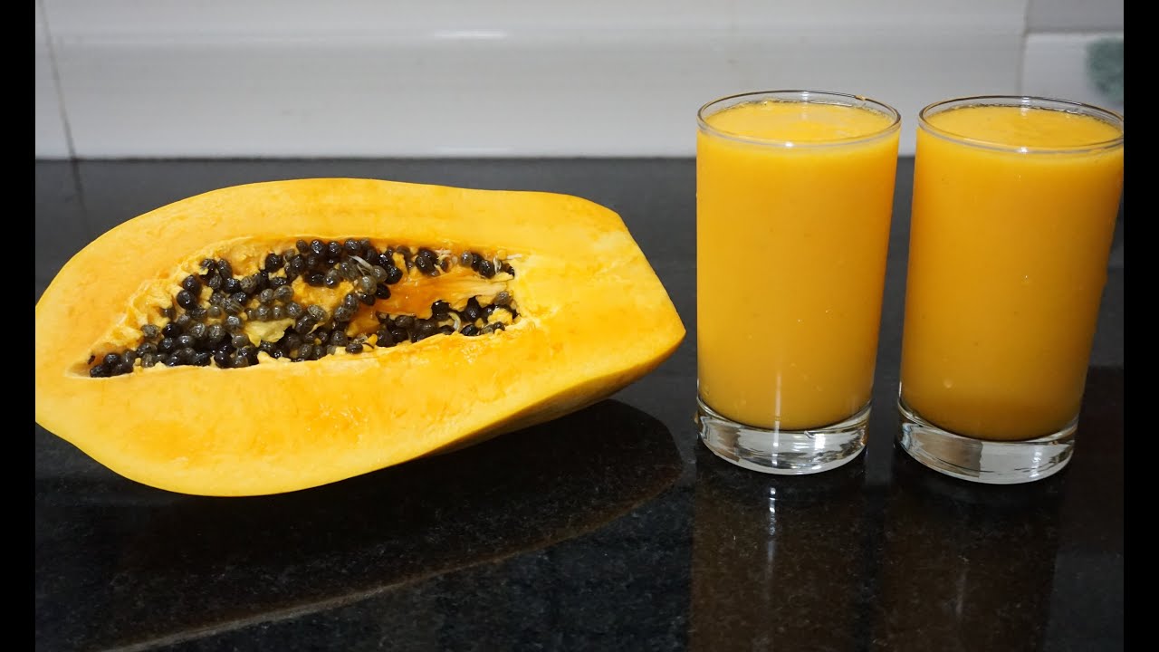 Papaya juice and ripe fruit with seeds