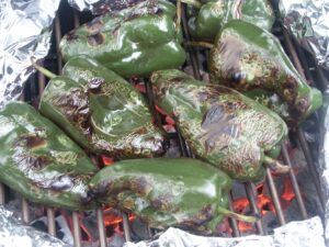 Grilling chile peppers on a charcoal grill