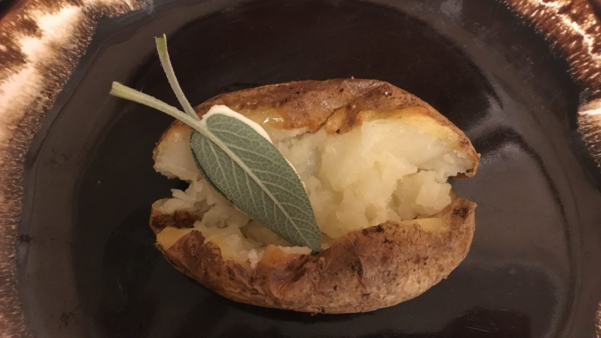 Sage leaf and butter on baked potato