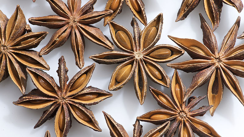 A number of brown, star-shaped seed pods of star anise.
