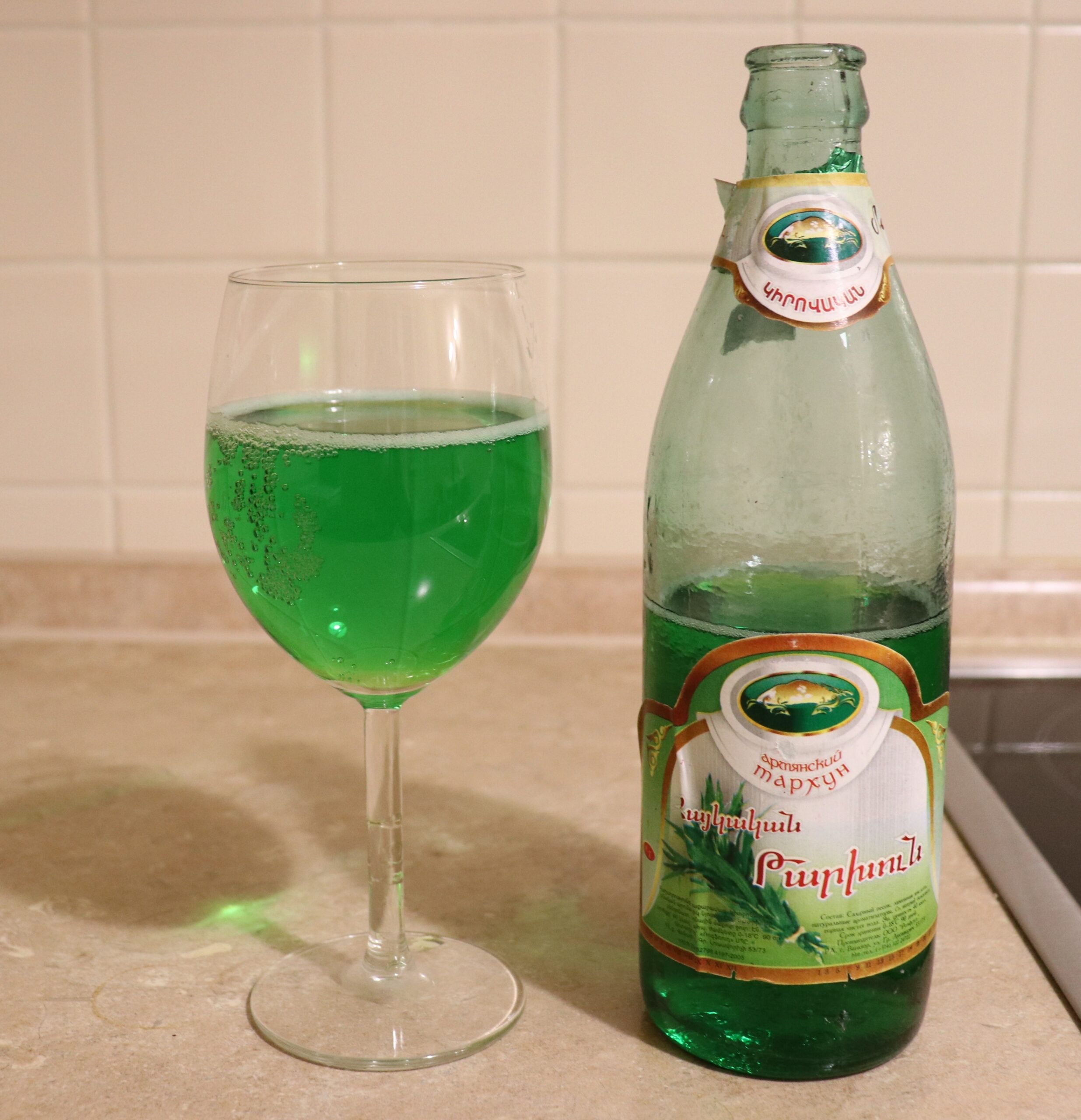 Open bottle and glass of Tarkhuna beverage